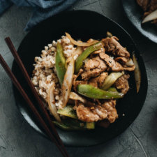 Tender juicy pork, stir fried with crispy peppers and onions in a garlicky savory sauce. Not only is it so easy and fast to make, but it also makes a great weekday main dish with affordable ingredients and is loaded with nutrition. #pork #pepper #stirfry #recipes #dinner