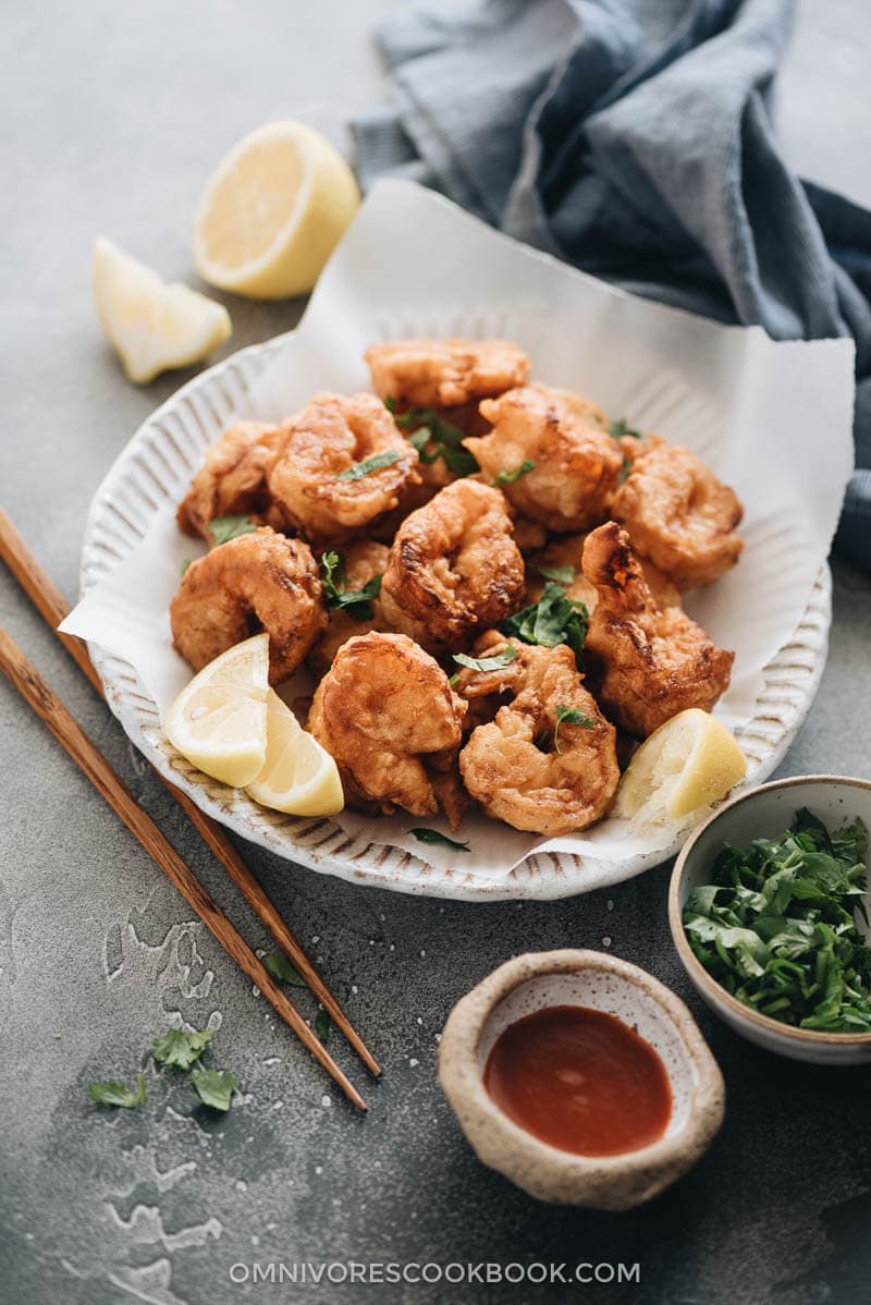 Fried shrimp served in plate with parchment paper closeup