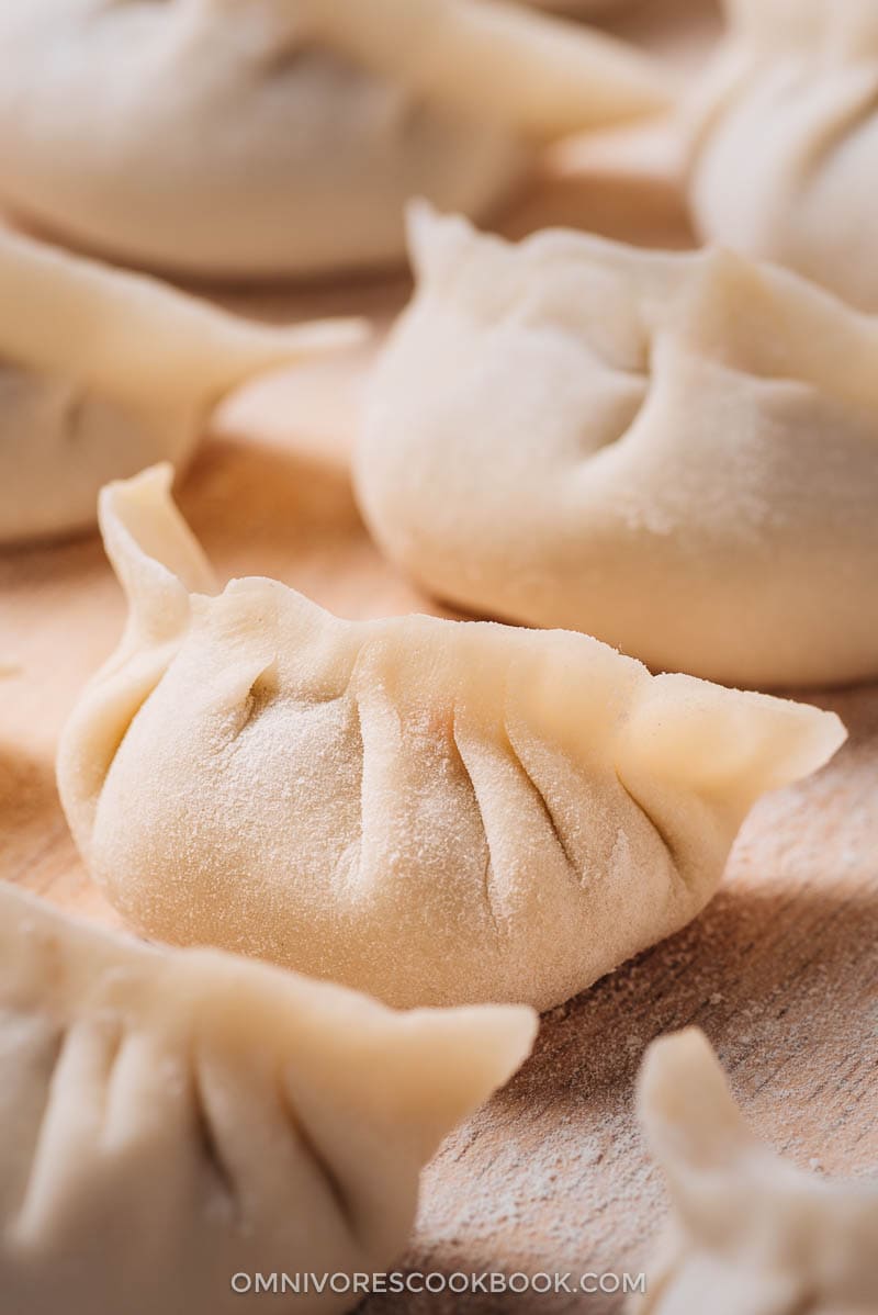 Chinese Dumplings | The ultimate guide to making Chinese dumplings from scratch. The dough can be used for both boiled dumplings (shui jiao, 水饺) and potstickers (guo tie, 锅贴). The dumpling wrappers are tender and thin, with a silky mouthfeel Uncooked Chinese dumplings close-up
