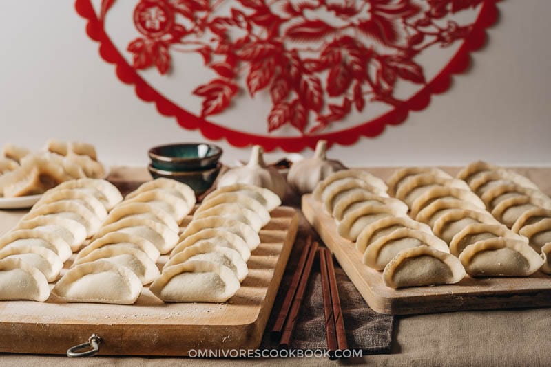 Chinese Dumplings | The ultimate guide to making Chinese dumplings from scratch. The dough can be used for both boiled dumplings (shui jiao, 水饺) and potstickers (guo tie, 锅贴). The dumpling wrappers are tender and thin, with a silky mouthfeel Uncooked Chinese dumplings on cutting boards