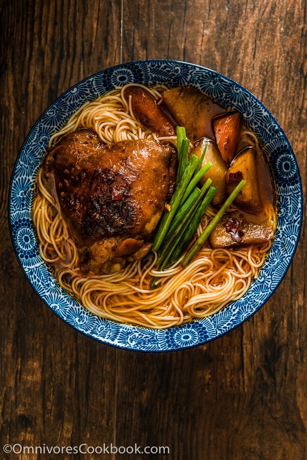 These spicy chicken noodles feature a super rich broth with juicy chicken. Learn to use the steam braising skill to cook a very flavorful chicken in much less time! | omnivorescookbook.com