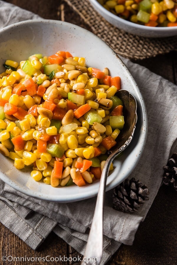 Stir Fried Corn with Pine Nuts (松仁玉米) - The sweet corn kernels, pine nuts, cucumber, and carrot are lightly seasoned with green onion, salt, and sugar. Every ingredient comes together to create a hearty meal that is nutty and sweet | omnivorescookbook.com