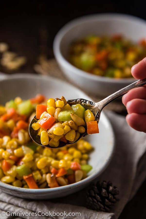 Stir Fried Corn with Pine Nuts (松仁玉米) - The sweet corn kernels, pine nuts, cucumber, and carrot are lightly seasoned with green onion, salt, and sugar. Every ingredient comes together to create a hearty meal that is nutty and sweet | omnivorescookbook.com