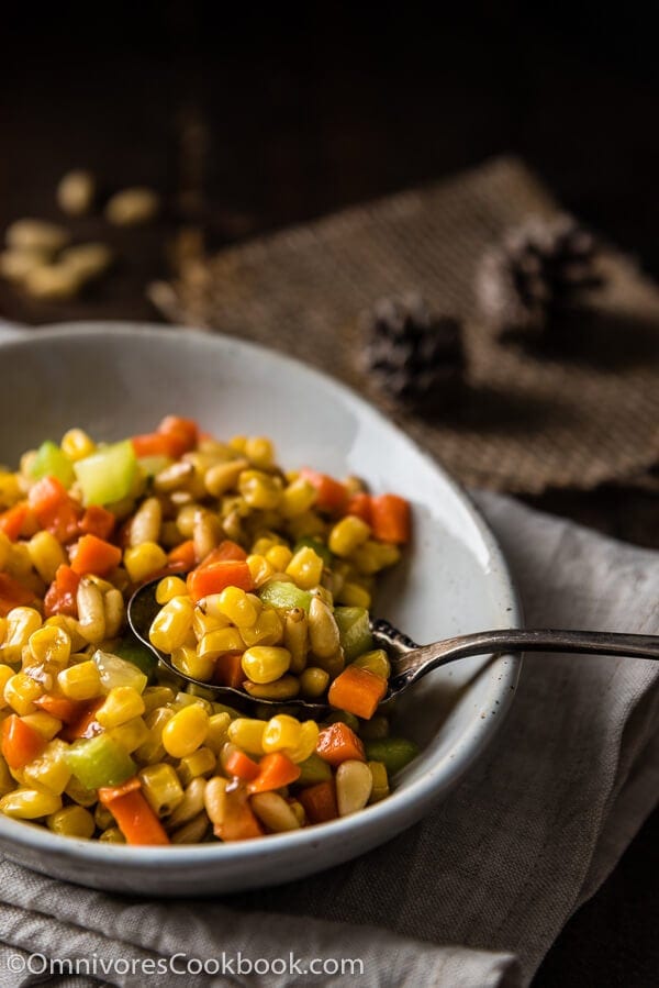 Stir Fried Corn with Pine Nuts (松仁玉米) - The sweet corn kernels, pine nuts, cucumber, and carrot are lightly seasoned with green onion, salt, and sugar. Every ingredient comes together to create a hearty meal that is nutty and sweet | omnivorescookbook.com
