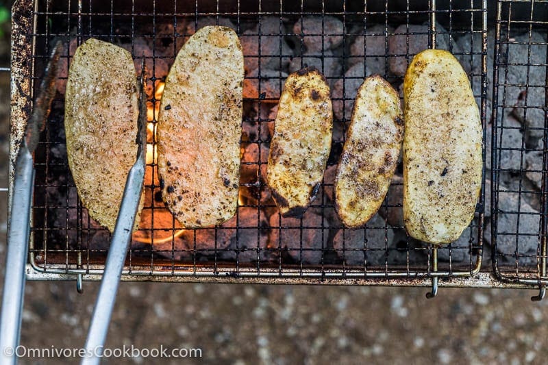 Cook the best grilled potato by slicing it finely, grill until blistered on the surface and creamy in texture. Add cumin and chili powder to spice it up.