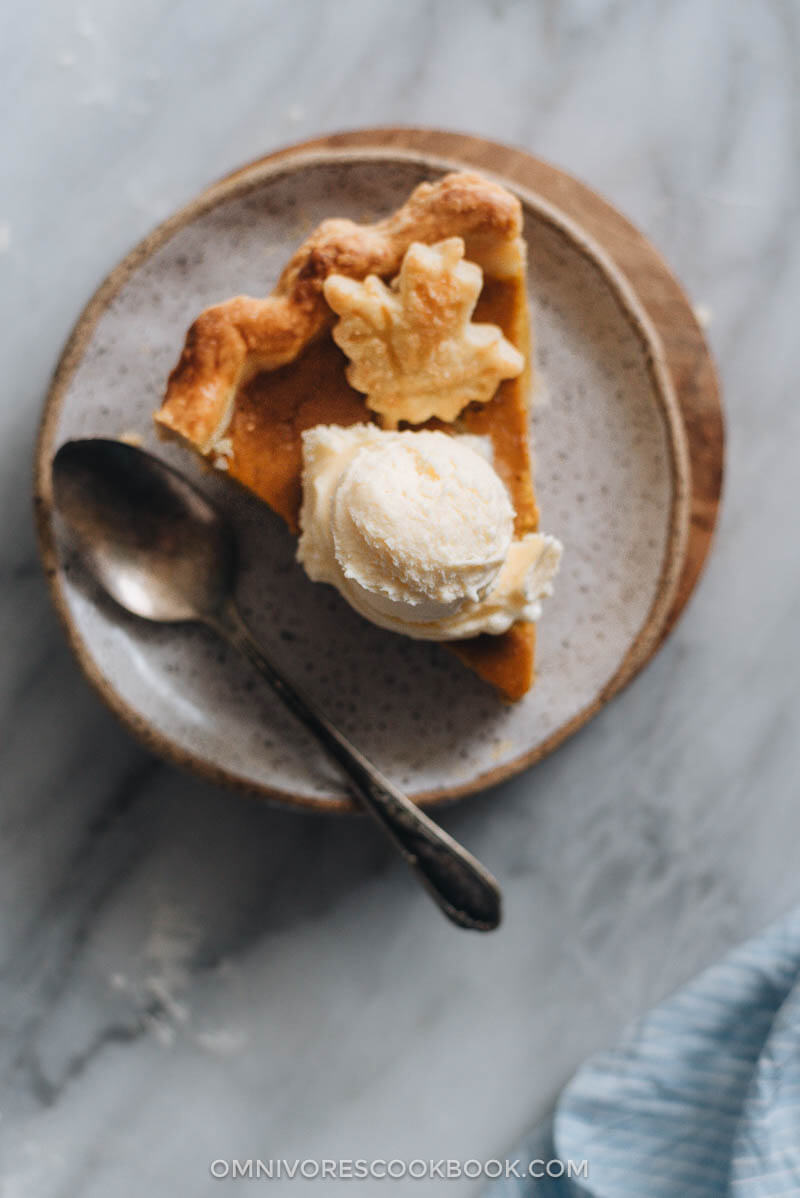 Slice of kabocha pumpkin pie topped with ice cream.