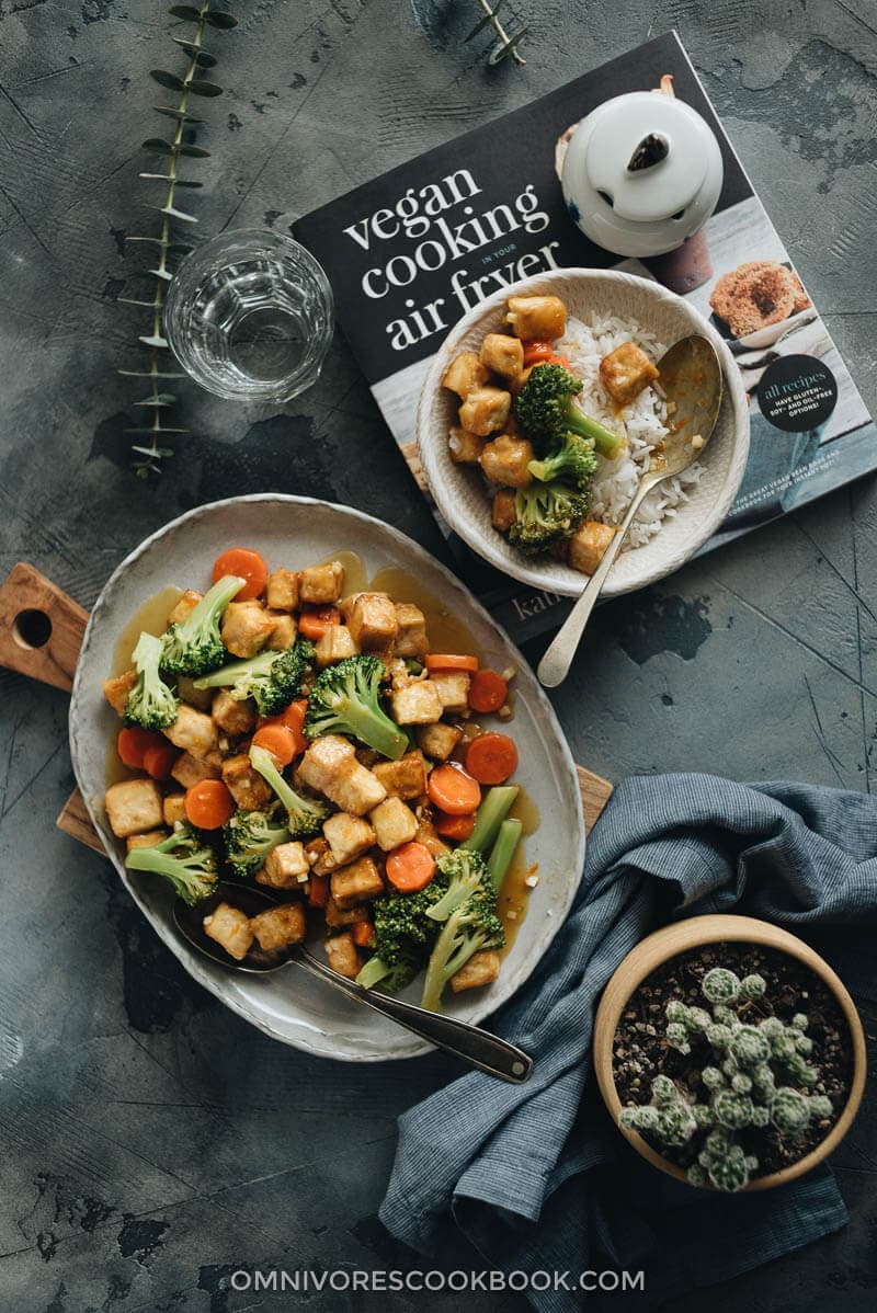 Air Fryer Tofu with broccoli and carrot served in big plate, small serving bowl on the side