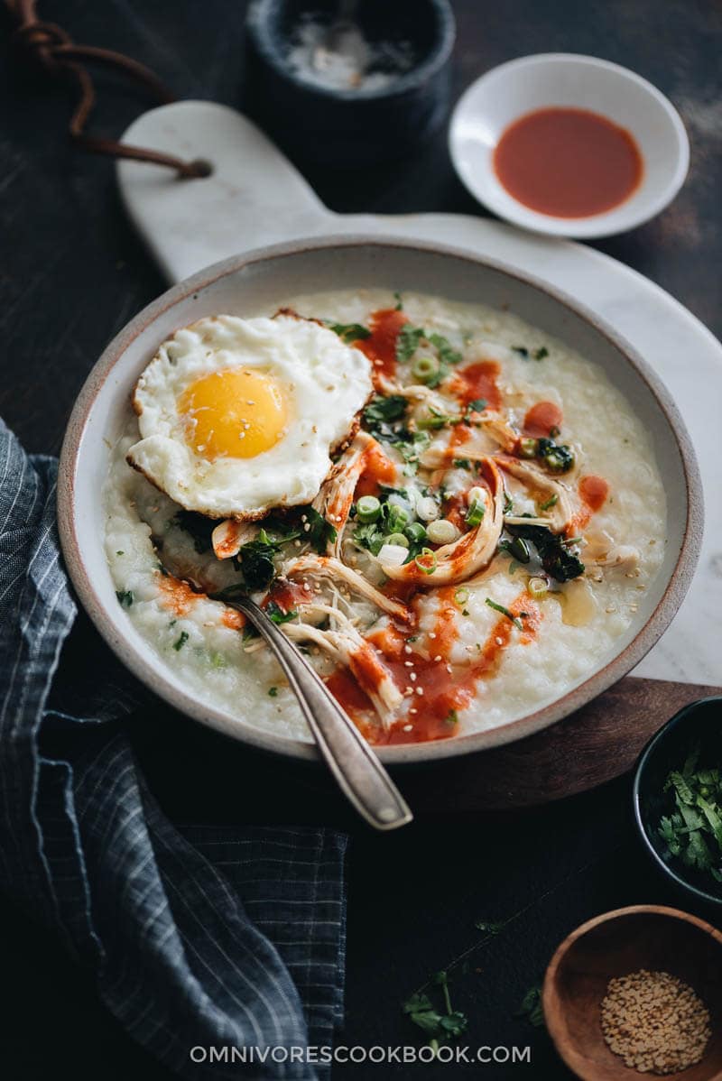 Instant Pot congee with chicken and spinach topped with egg served in a bowl