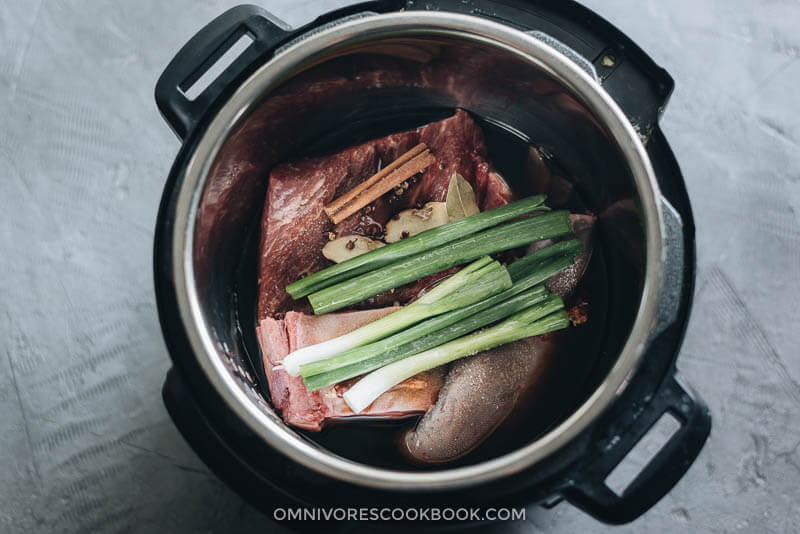 Beef brisket and beef tongue with seasonings in Instant Pot