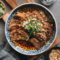 This Fu Qi Fei Pian (Sichuan Sliced Beef in Chili Sauce) recipe gives you the real-deal Sichuan experience. The tender beef slices are served in a rich, spicy hot sauce and topped with peanut flakes and cilantro. #glutenfree #beef #instantpot #chinese #recipes