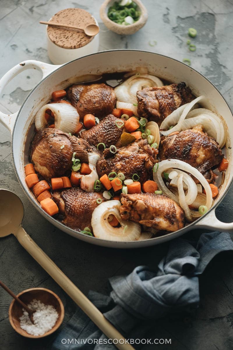 Filipino chicken adobo with onion and carrot in dutch oven