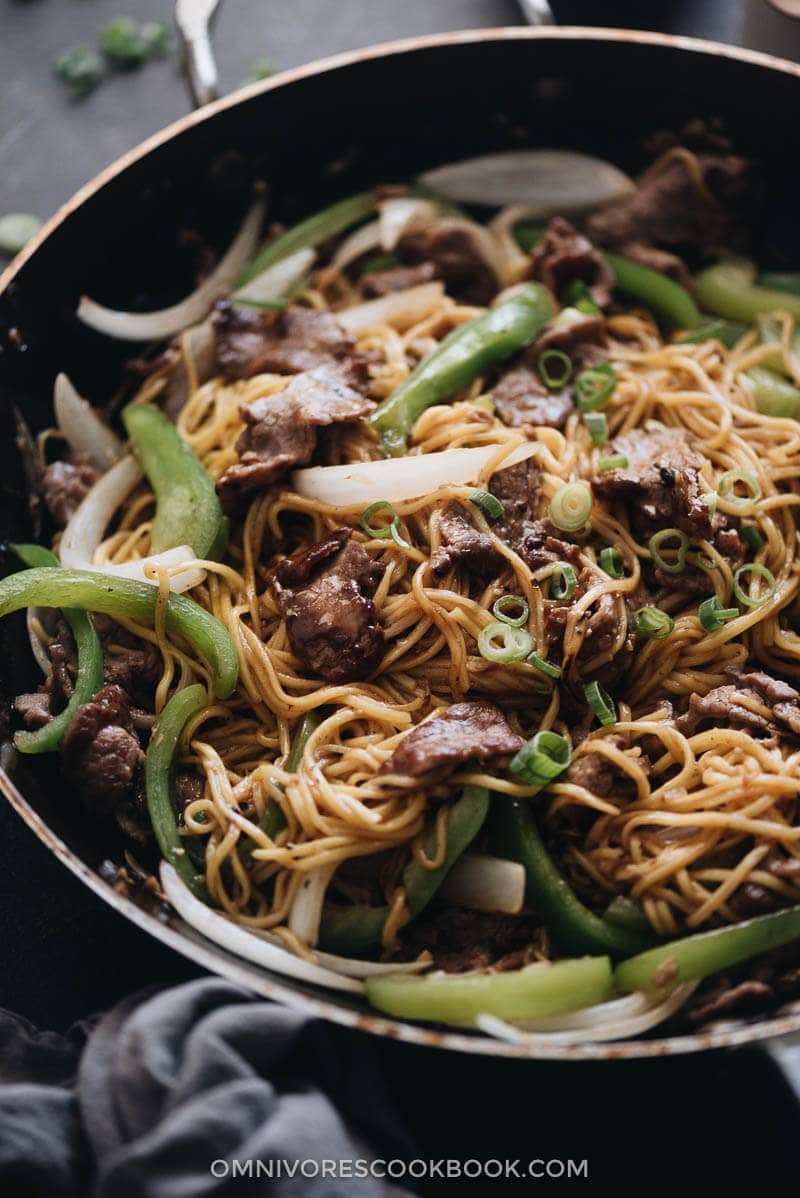 Homemade beef chow mein with peppers and onion close up
