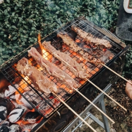 Grilling beef satay on a Chinese grill
