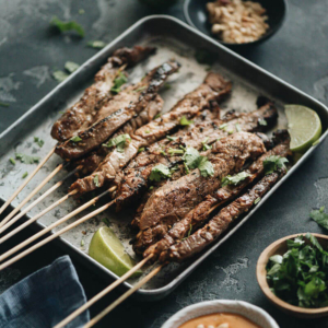 Beef Satay - Skewers of flavorful beef get that perfect char over the Chinese grill and are served with a sweet, tangy and totally craveable peanut sauce. #marinade #recipe #sticks #gluten-free