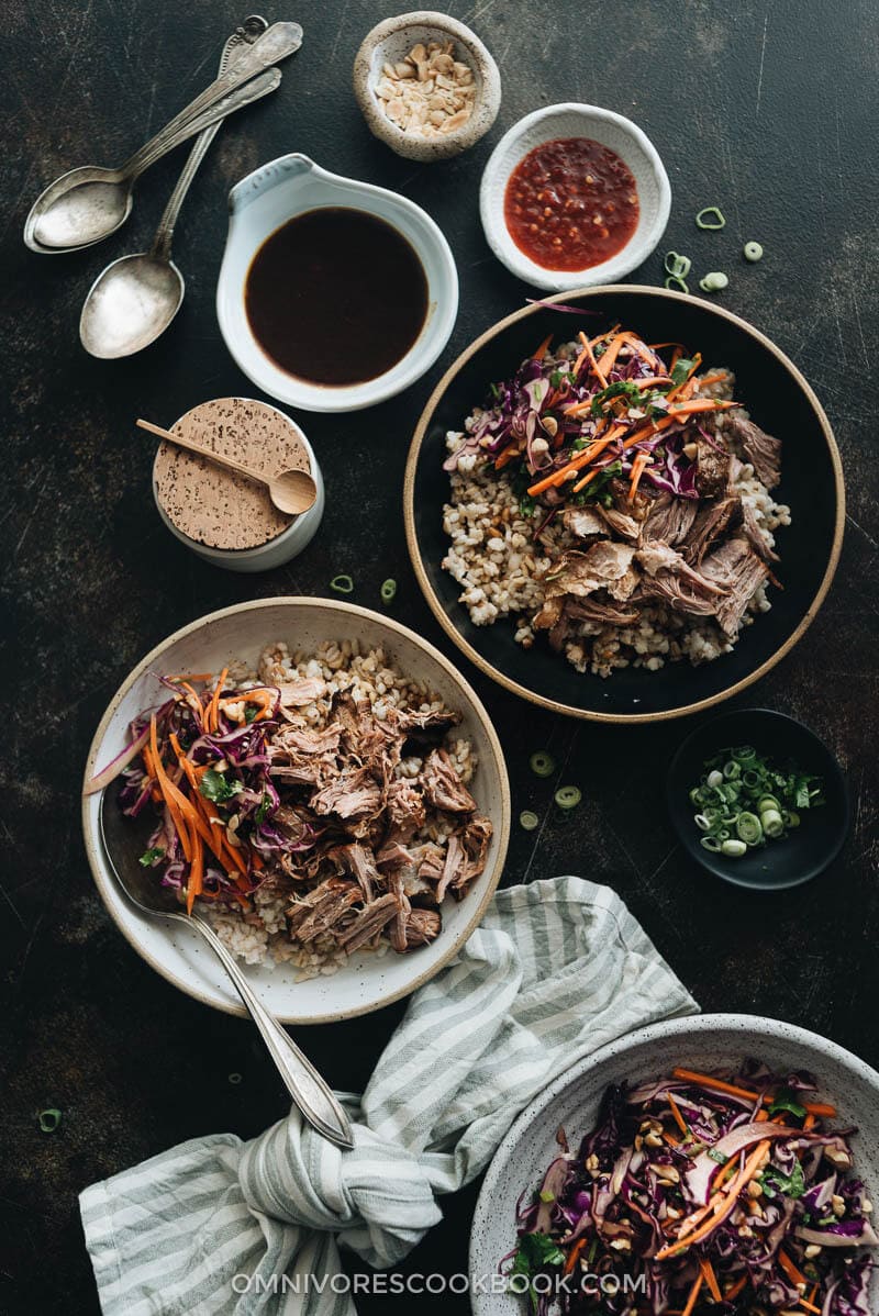 Asian Instant Pot pulled pork served on steamed brown rice with sauce on the side