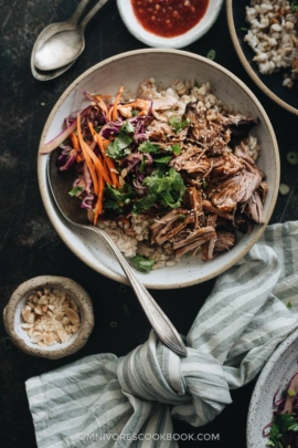 Asian Instant Pot pulled pork served on steamed brown rice and coleslaw