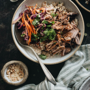 Asian Instant Pot pulled pork served on steamed brown rice and coleslaw