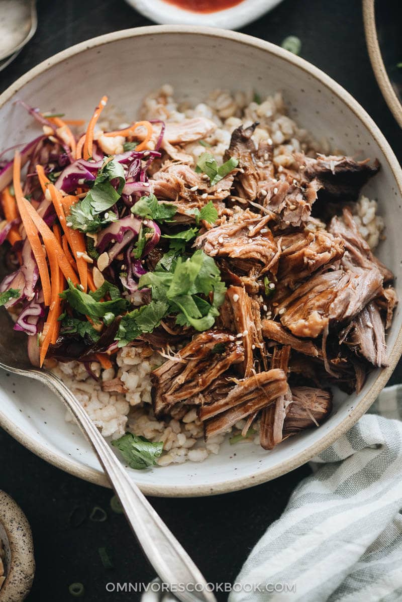 Asian Instant Pot pulled pork served on steamed brown closeup