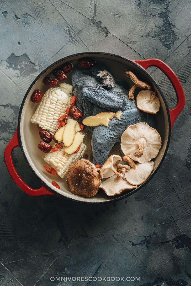 Chinese silkie chicken soup ingredients in a dutch oven