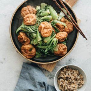 Stir fried baby bok choy with gluten balls served with brown rice