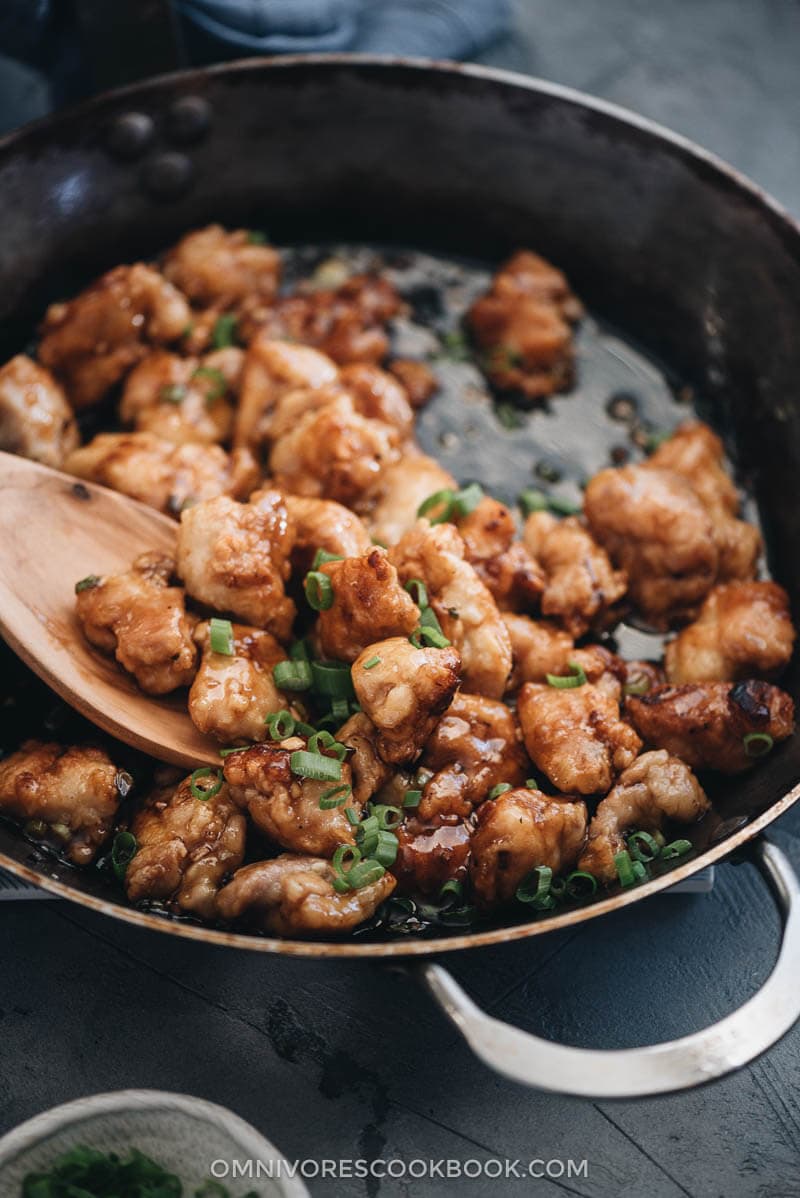 Crispy Chinese restaurant style honey chicken cooked in a skillet close up