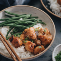 Homemade crispy Chinese honey chicken served in bowls close up