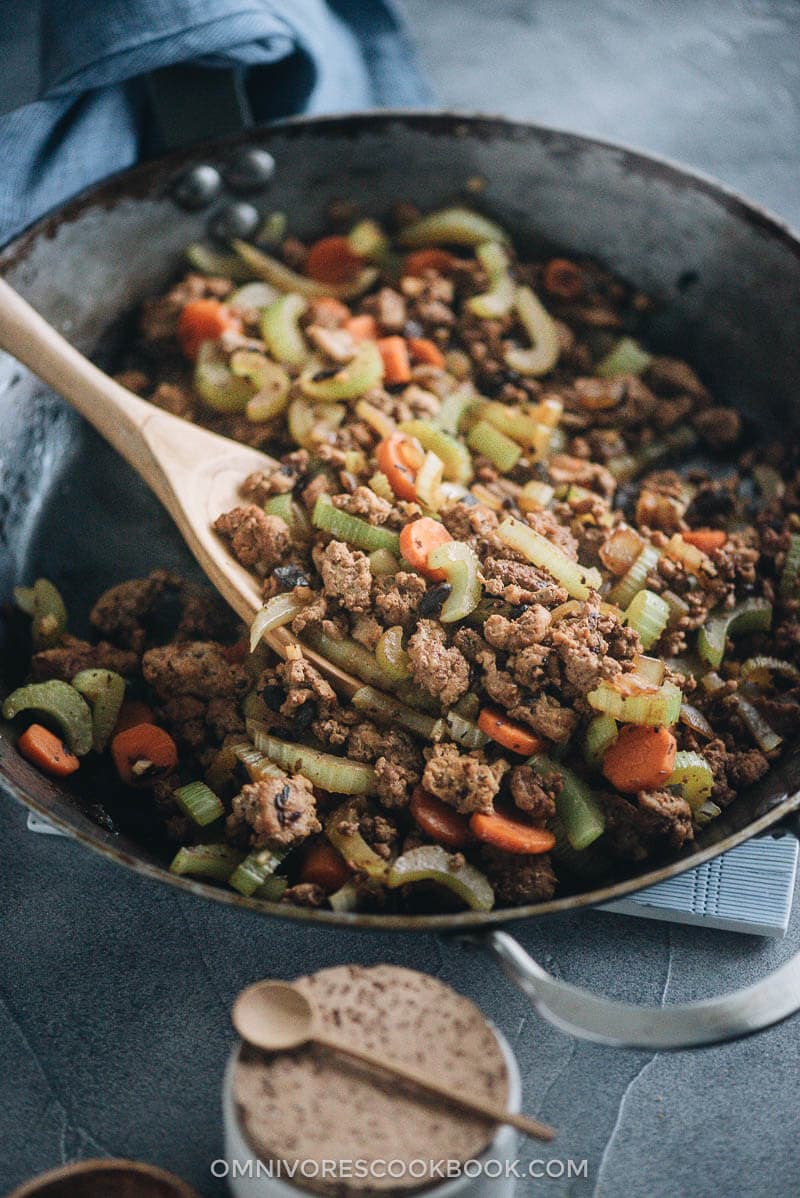 Ground beef stir fry with celery in a frying pan close up