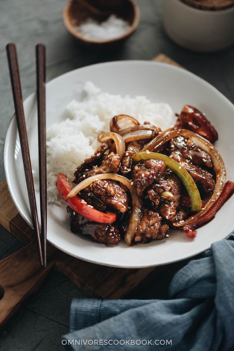 Szechuan beef stir fry served in a plate with rice