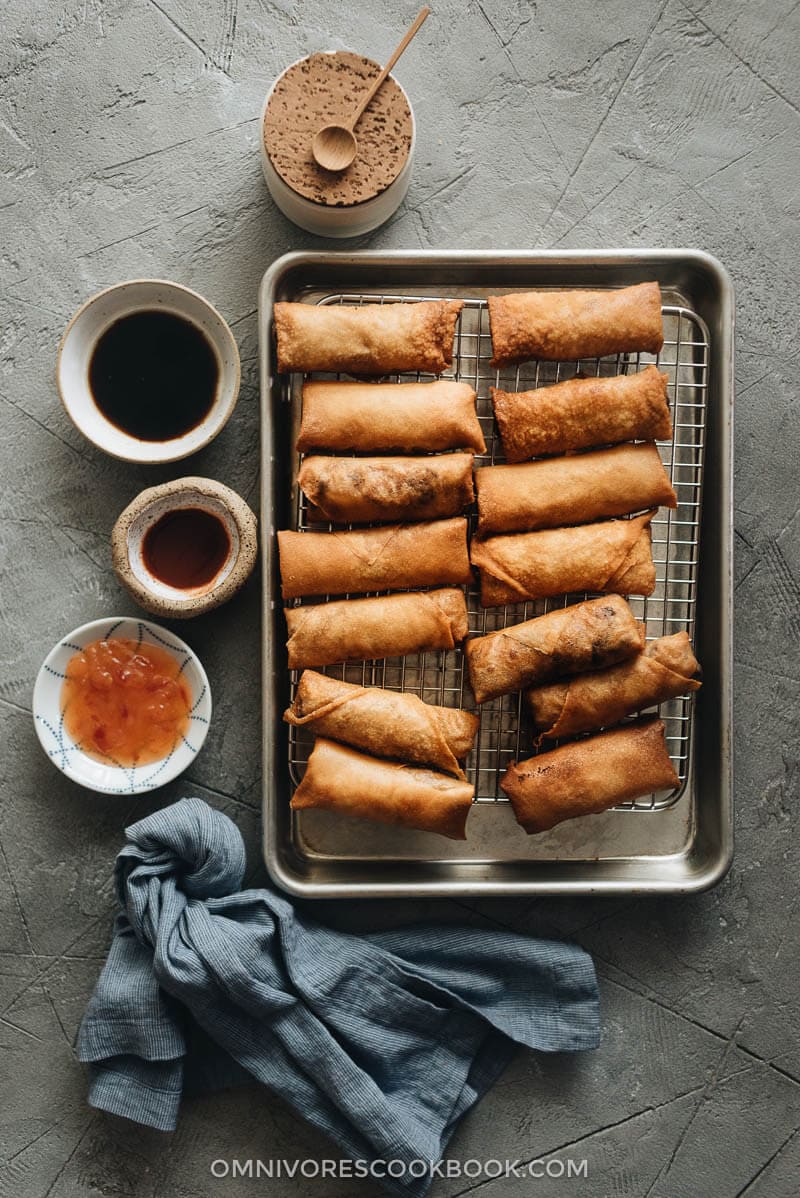 Fried Chinese egg rolls on cooling rack