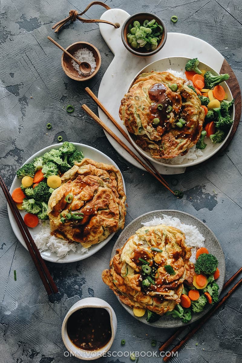 Egg foo young served with rice and veggies with gravy