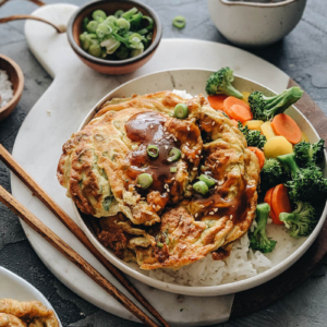 Egg foo young with gravy on rice