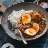 Egg curry served with steamed rice in a bowl