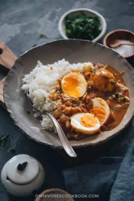 Egg curry served with steamed rice in a bowl