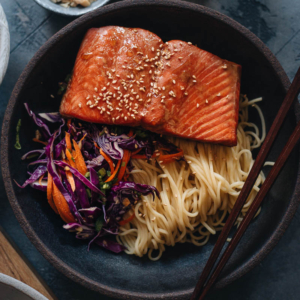 30-Minute Salmon Noodle Bowl with Coleslaw - Tender flaky juicy baked salmon served on noodles with coleslaw in a garlicky gingery savory sauce that’s lightly sweet. This recipe uses a blender to mix one sauce that is used as the salmon marinade and in the noodle sauce, so it literally takes 10 minutes to get ready. It’s a perfect dish for your busy weekday dinners and meal-prep. {Gluten-Free Adaptable}