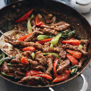 Ginger Beef | Crispy juicy beef, crunchy bell peppers, and tender baby bok choy are tossed in a rich sauce that is sweet, spicy, sour, and peppery. Pair this ginger beef stir fry with a bowl of rice to soak up the deep, arresting flavors of the sauce, and you’ll have a princely takeout favorite with ten times the taste! {Gluten-free adaptable}