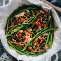 Steamed Salmon in Black Bean Sauce - The steamed salmon is cooked until tender and moist and the asparagus perfectly done. The dark black bean sauce complements both ingredients perfectly and turns these simple ingredients into a feast. The dish takes no time to set up and cook. And you’ll get a nutritious and delicious one-pan dinner in 30 minutes. {Gluten-Free adaptable}