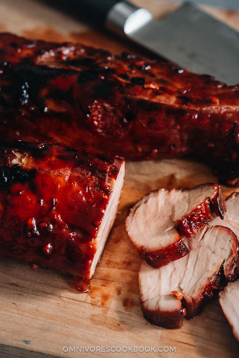 Sliced Chinese BBQ pork on cutting board close-up