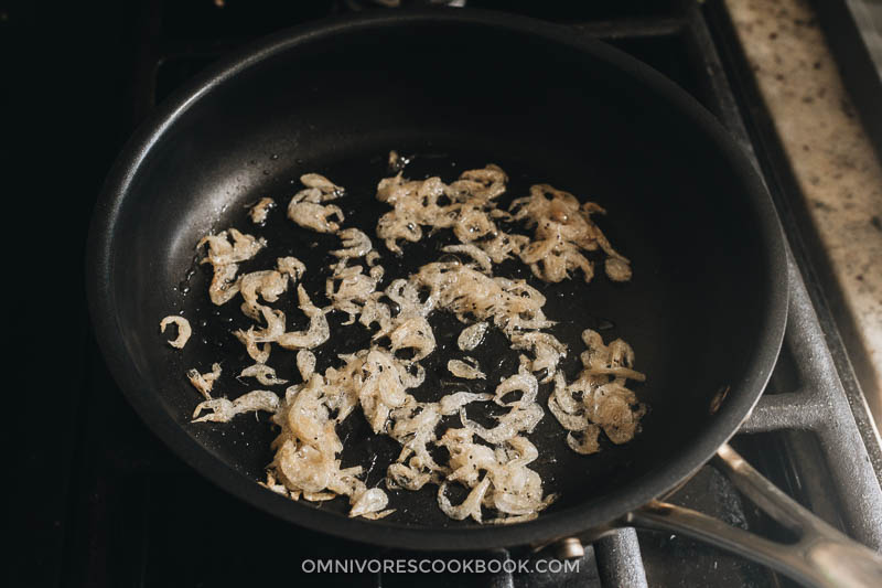 Toast dried papery shrimps in skillet