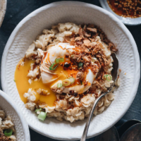 5-Ingredient Savory Oatmeal (Chinese-Style) | This oatmeal is simmered with chicken stock until creamy, topped with runny eggs, seasoned with soy sauce and chili oil, and finished up with crispy fried shallots. This breakfast dish is so easy to put together and the combo creates a bold taste with a beautiful texture. {Gluten-Free adaptable}