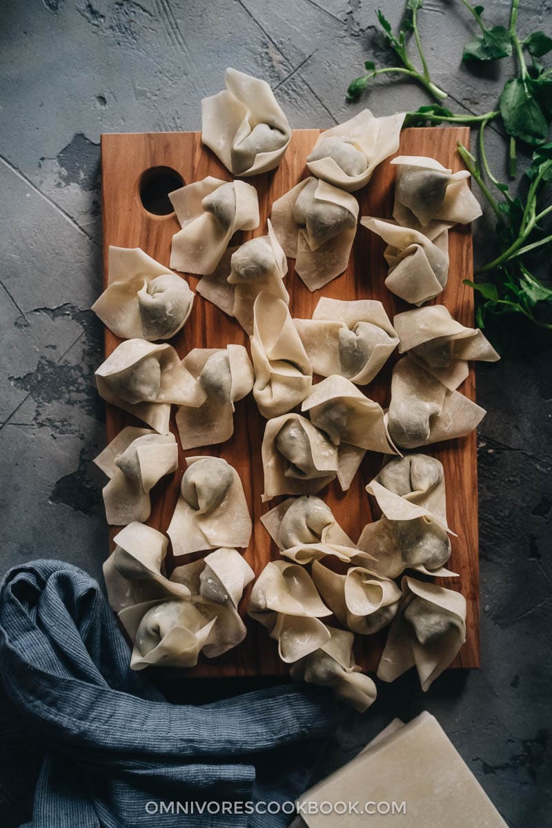 Uncooked wontons on a cutting board