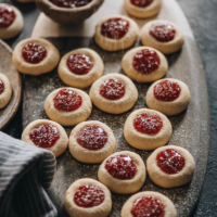 Strawberry thumbprint cookies dust with powdered sugar