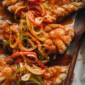Chinese Sweet and Sour Fish (糖醋鱼) | This recipe uses fish fillets to create a stunning presentation while keeping the cooking process as easy as possible. The fish is shallow-fried until super crispy and then drizzled with a rich and aromatic sauce that is loaded with colorful peppers. It’s a perfect dish to serve at your dinner party, for Chinese New Year, or for other Chinese festivals. {Gluten-Free Adaptable}