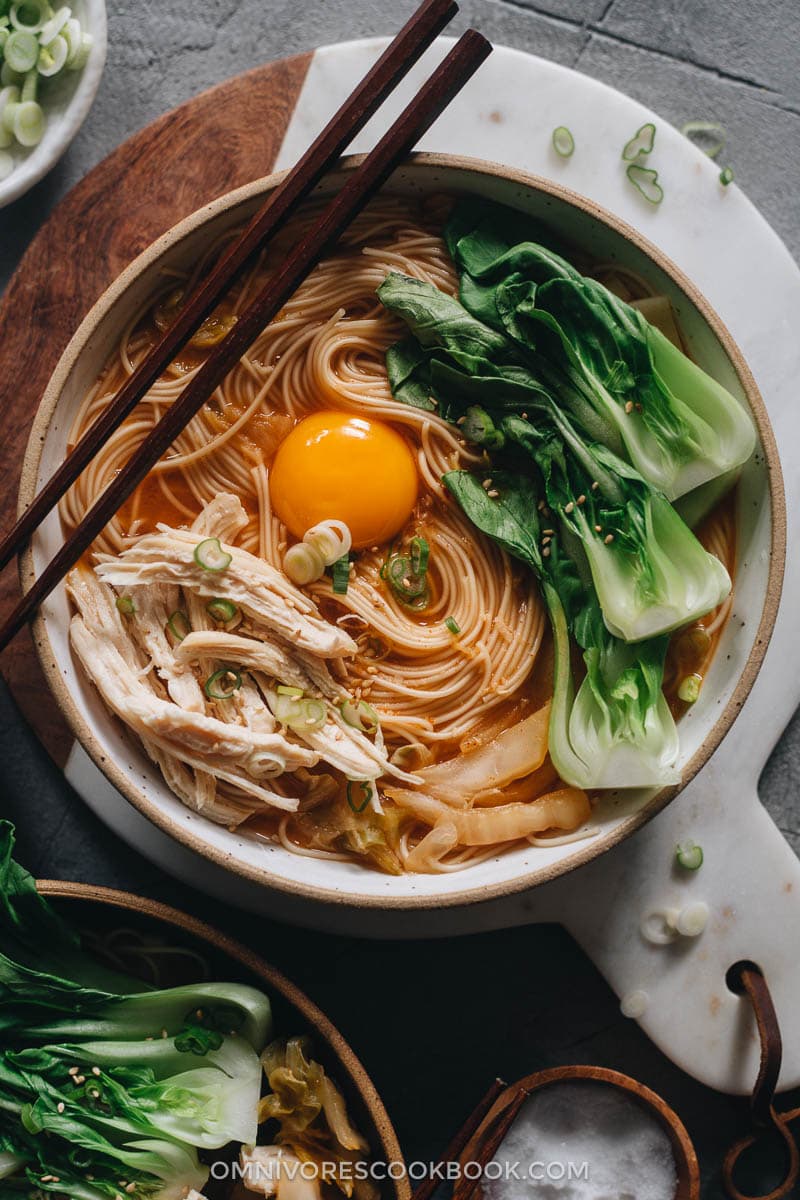 Korean noodle soup with chicken, egg and baby bok choy