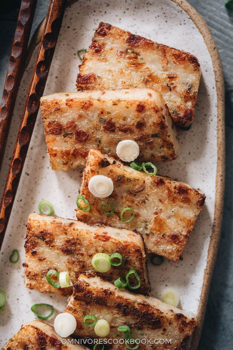 Chinese lunar new year food concept, Delicious turnip radish cake, local  cuisine in restaurant with soy sauce on red background, close up, copy  space Stock Photo by ©romixcontact@gmail.com 317293965