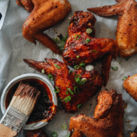 Learn how to make Chinese baked hot wings that have a crisp outer texture with a savory spicy heat. They’re perfect for game days, parties, or any time you’re craving wings. Brush them with my homemade honey hot sauce - they are literally finger-lickering good!