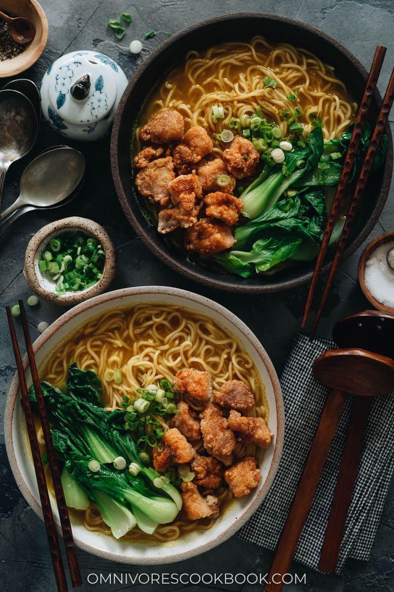 Curry noodle soup topped with popcorn chicken and baby bok choy