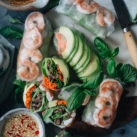Delicious fresh spring rolls are a light and healthy dish that you’ll have as much fun making as you will eating! The recipe includes shrimp and ground meat, but you can choose to use one protein or even skip the protein to make it vegetarian. It comes with two sauces - a peanut butter sauce and a Vietnamese dipping sauce. {Gluten-Free adaptable}