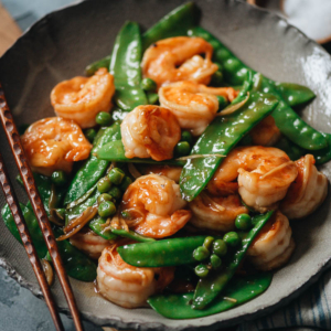 Juicy, tender shrimp with crispy snow peas in a refreshing and healthy gingery sauce. It’s a comforting Chinese takeout dish you can whip up quickly any night of the week! {Gluten-Free Adaptable}
