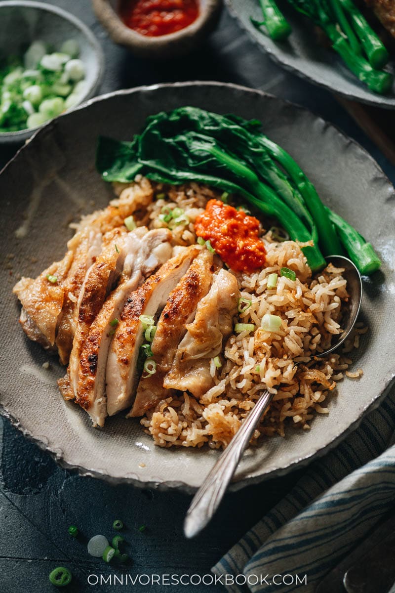 Carved chicken served on rice with Chinese broccoli
