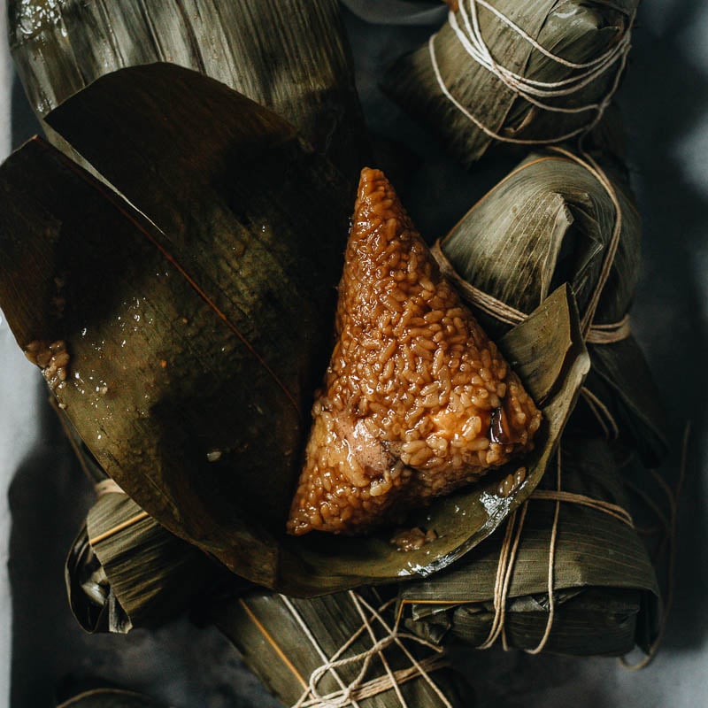 These savory sticky pork rice dumplings, known as pork zongzi, are a tasty treat and a perfect signature summer festival food! {Gluten-Free adaptable}
